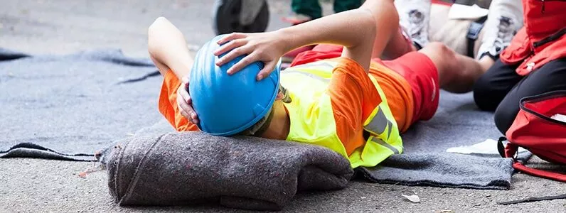Injured worker on the ground at a construction site